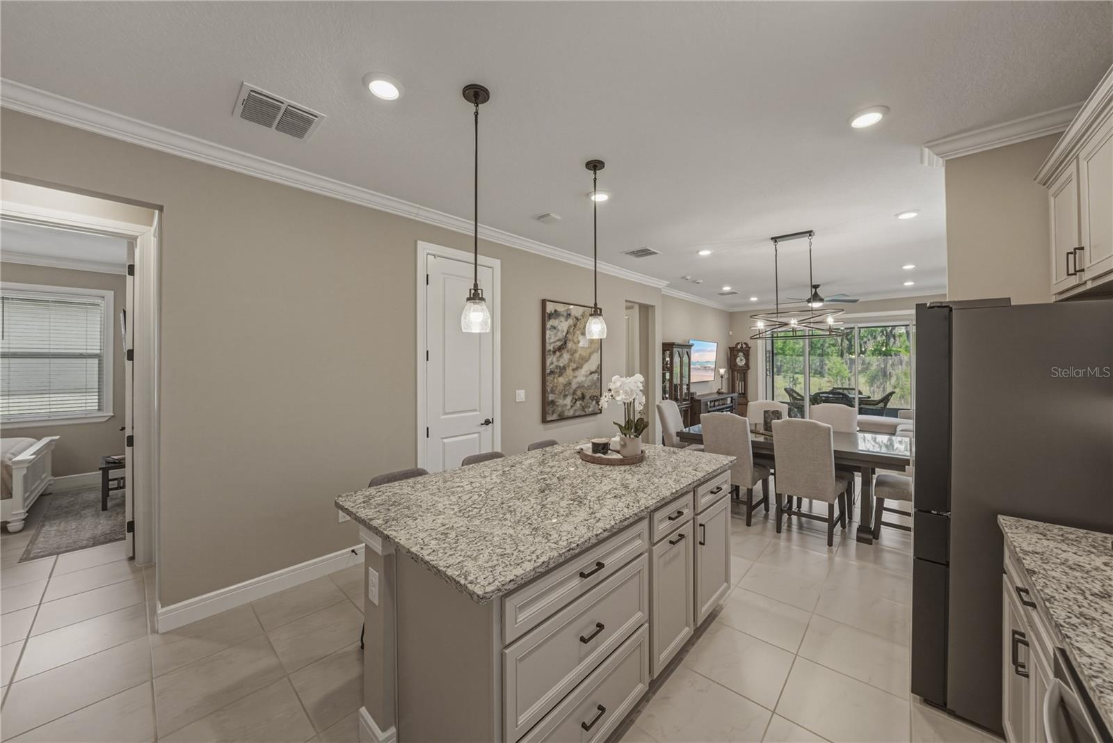 Large Center Kitchen Island with Trash and Recycle Built ins, Roll outs and Bar top seating