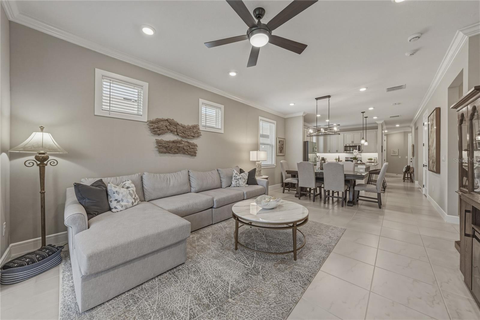 Spacious Great Room with Open Dining Area and Crown Molding Throughout