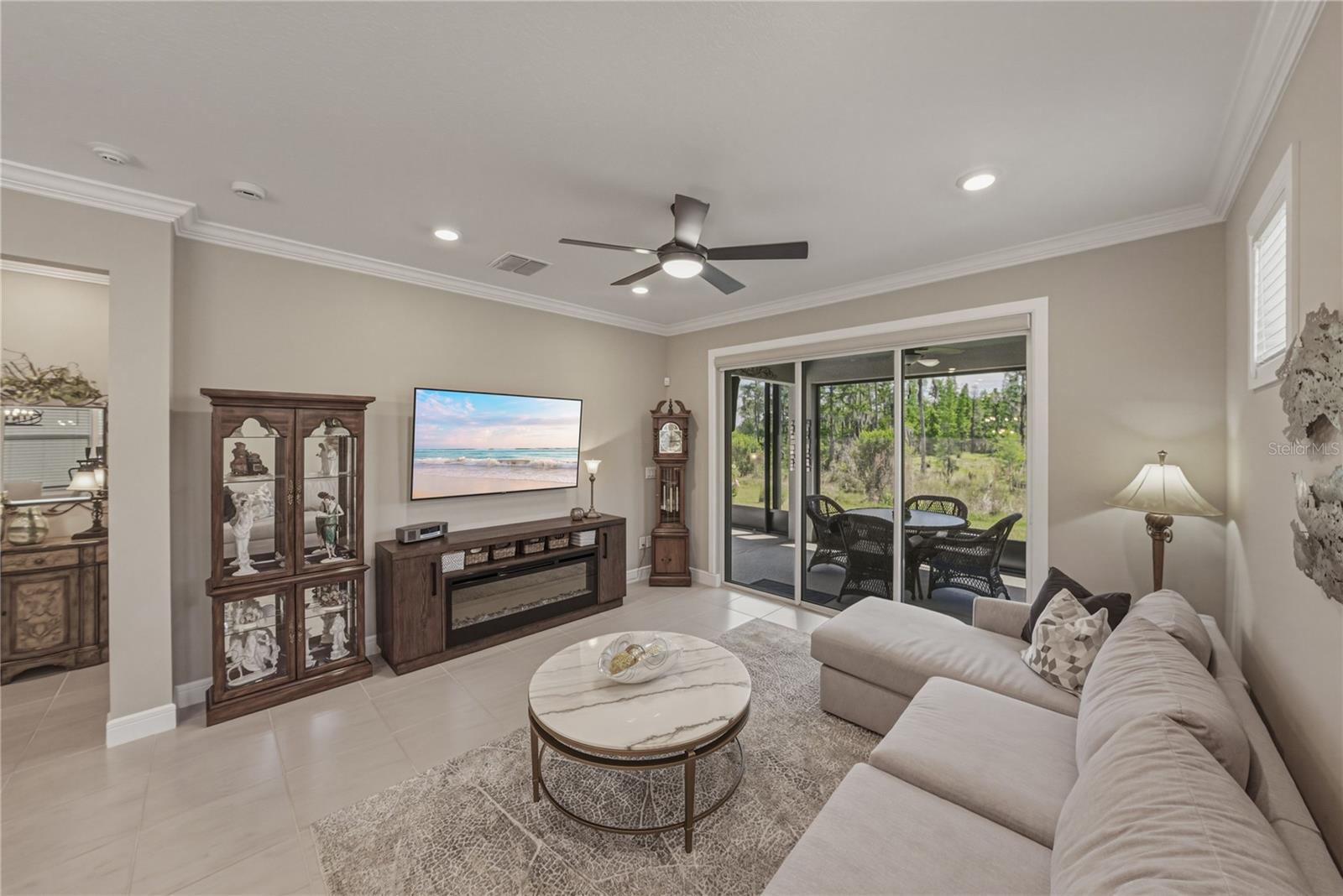 Great Room with upgraded lighting package and crown molding and solar shade