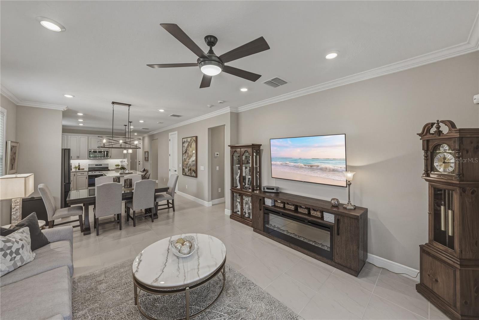 Great Room with upgraded lighting package, crown molding and all tile flooring