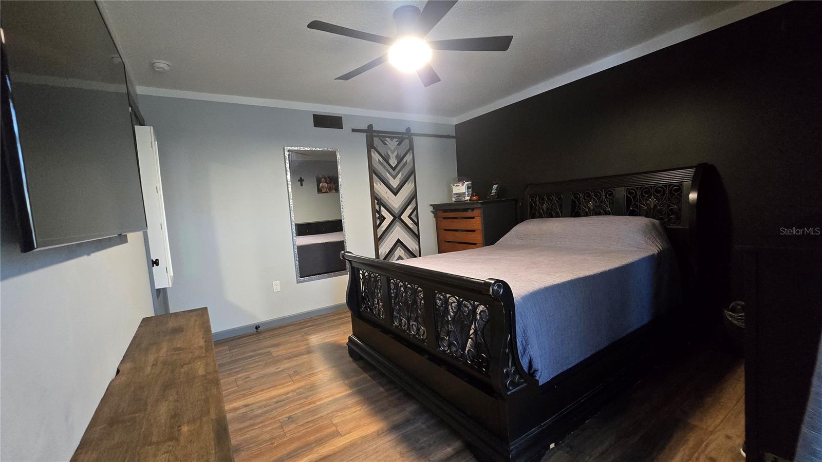 Owner's suite has slider access to the screened in lanai, a cool barn door to the ensuite bathroom, a walk in closet and plenty of room for your bedroom furniture.
