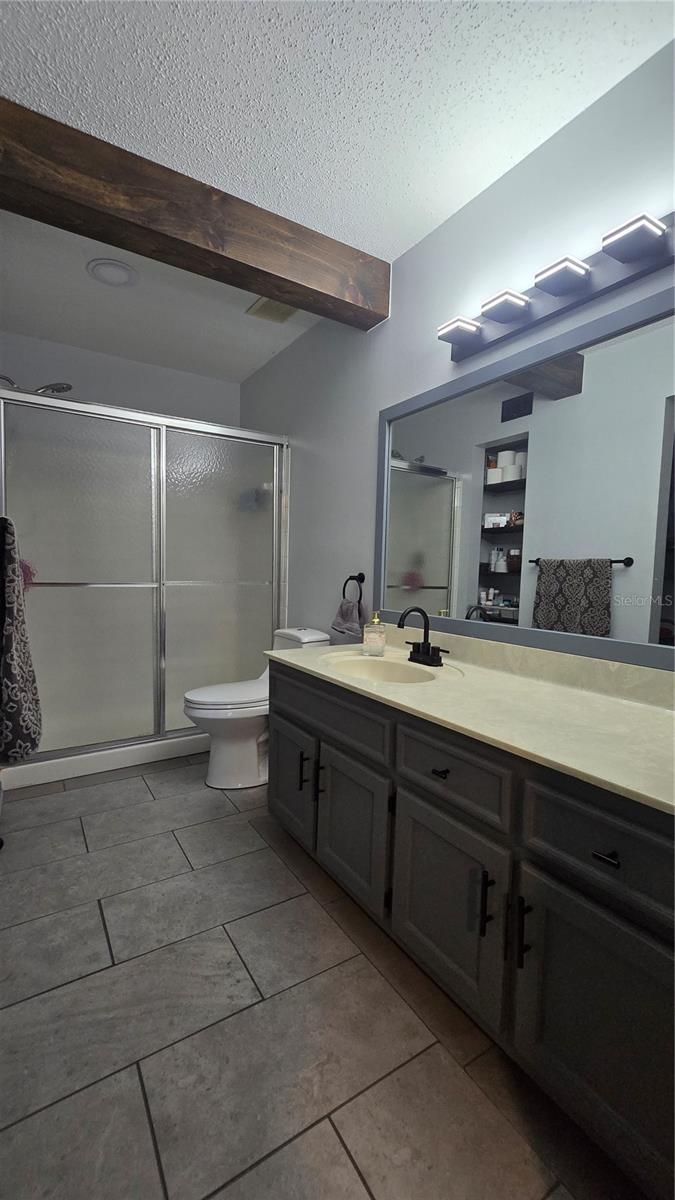 Owners suite bathroom offers an extended vanity, step in shower and linen closet.