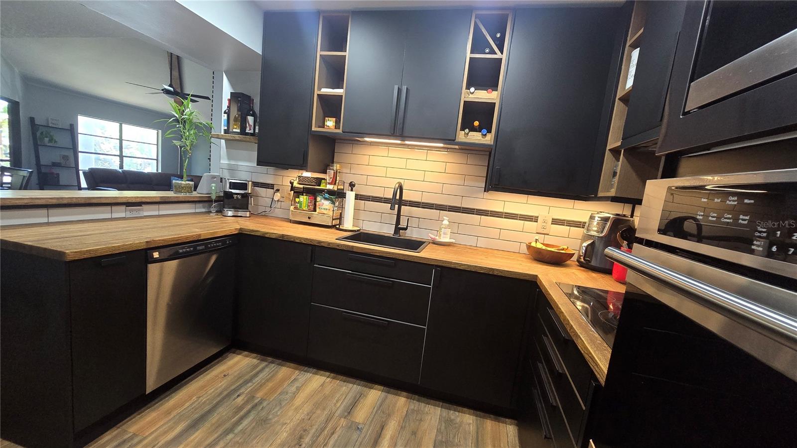 The kitchen cabinetry has a lot of cool features inluding pull out spice racks, wine rack, open shelving, soft close, fold out sponge and brush storage under the kitchen sink, pull out drawer under the sink for easy access to cleaning supplies. Kitchen faucet is brand new.