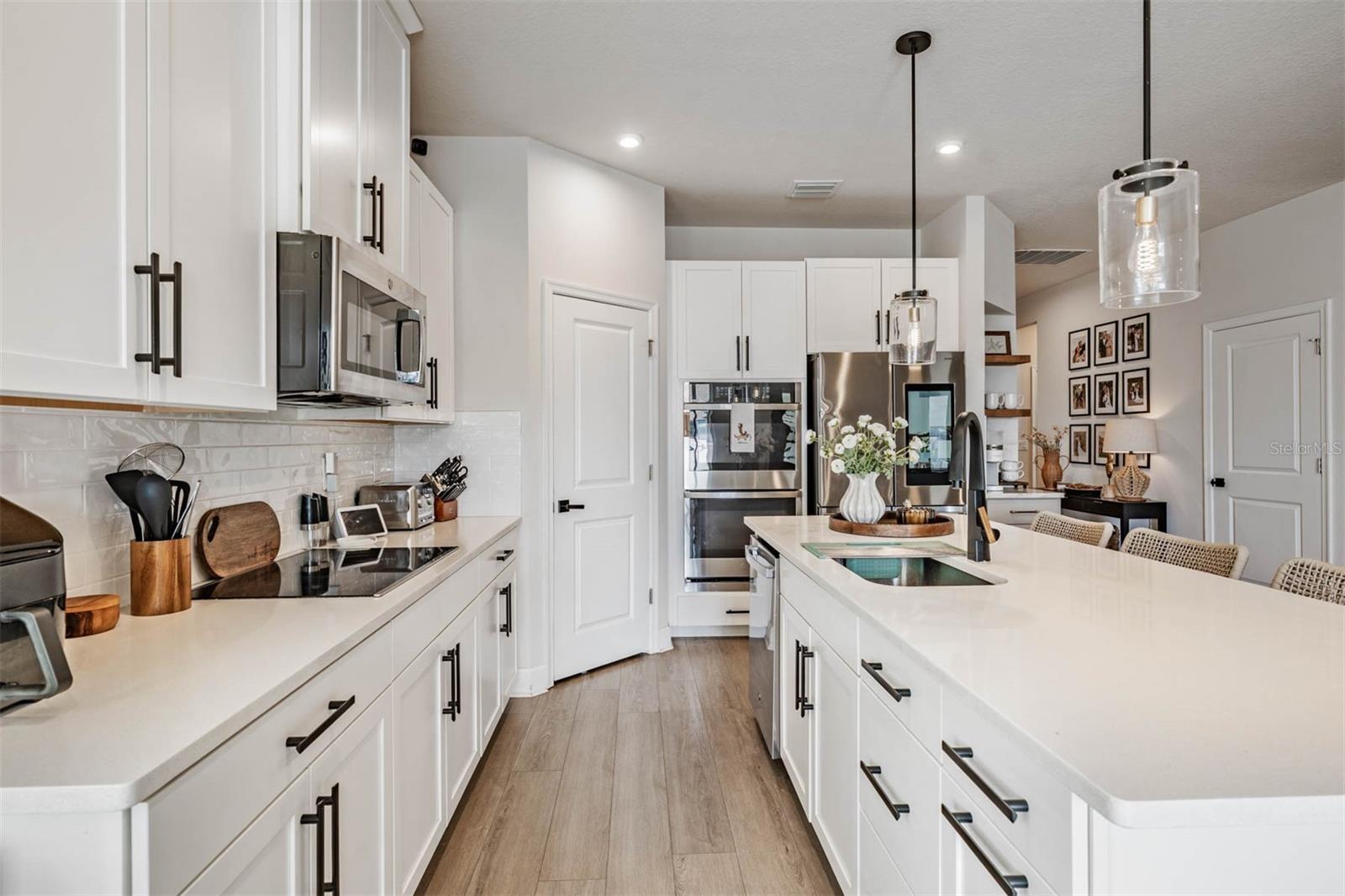 Quartz counters, pendant lighting and pantry closet
