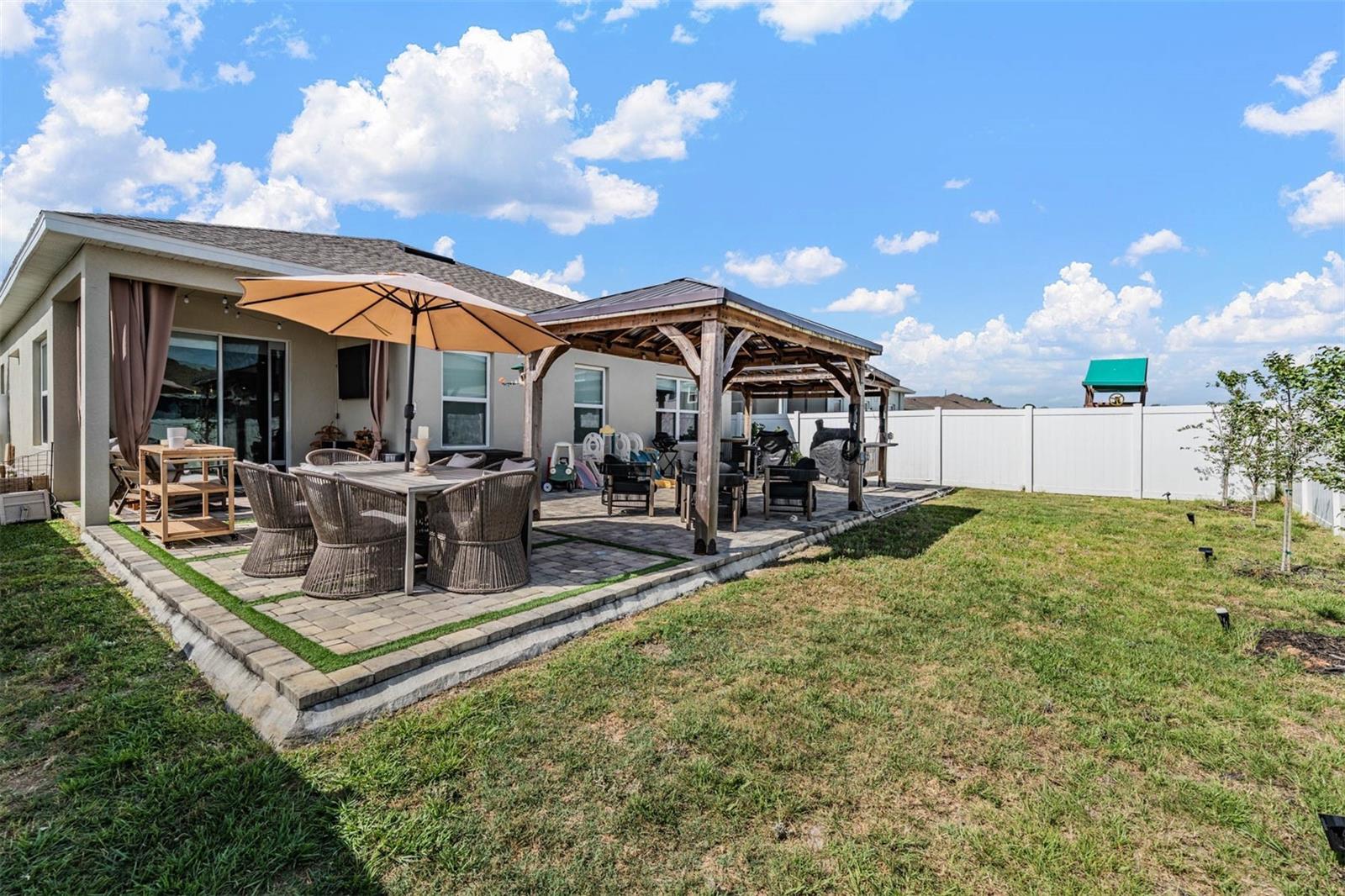 Fenced backyard with double gates on side