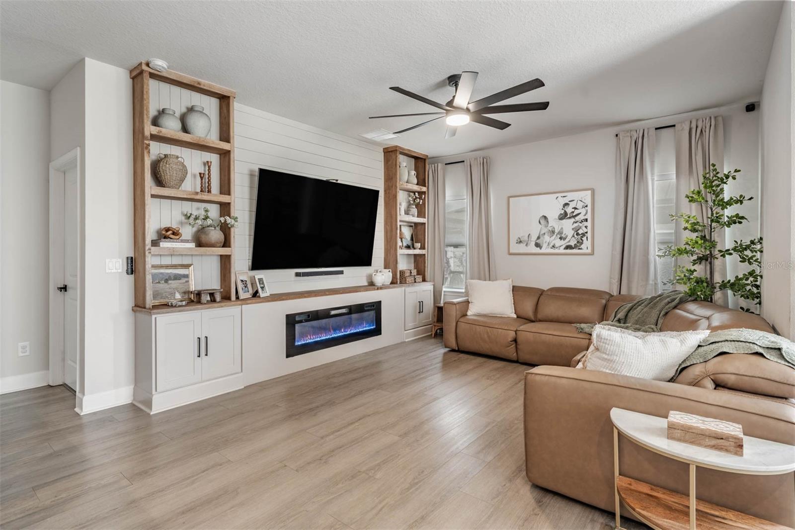 Built in bookshelves, electric fireplace and storage!