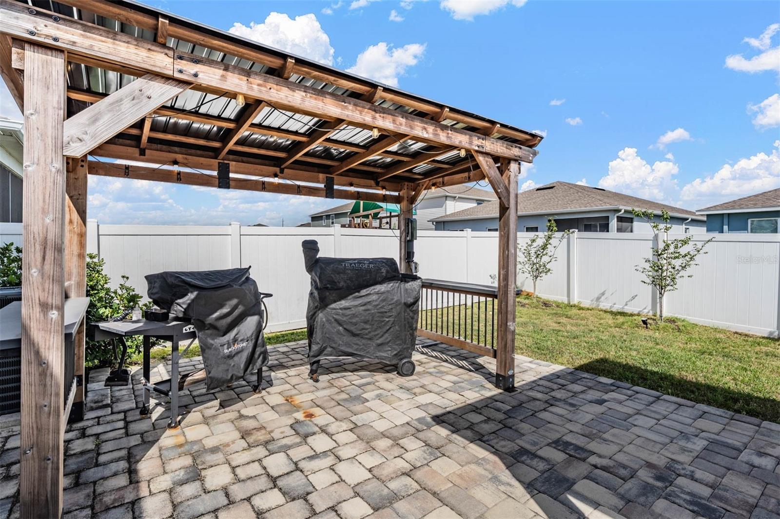 BBQ Gazebo on paver deck in fenced backyard
