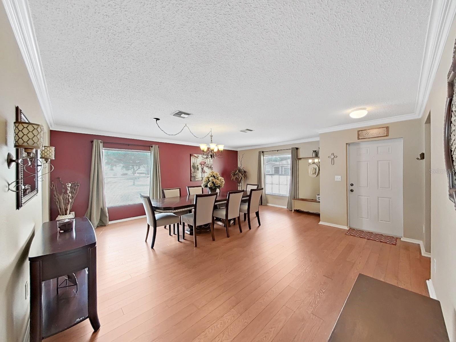 Gleaming floors, crown molding, and a chandelier-lit dining room that's ready for your biggest gathering!