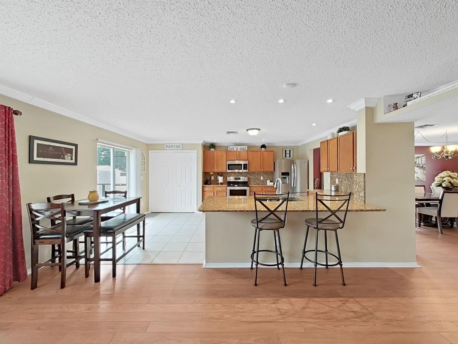 Open kitchen with Breakfast bar seating. Plenty of room for adjacent casual dining. Large Closet Pantry! Glass sliders open to the pool area.