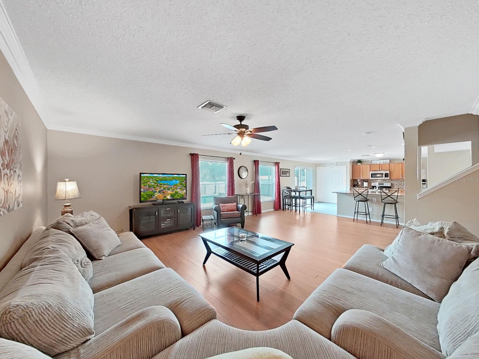The open floor plan you've been looking for - living room, dining, and kitchen all connected under one bright, airy space.