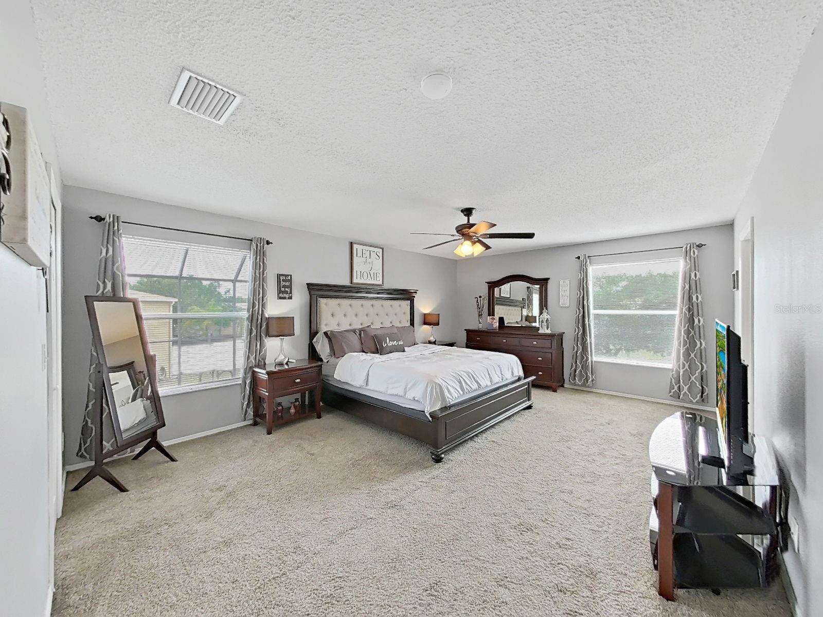 Your Primary Suite - a true spacious retreat with two separate sizable walk-in closets and plenty of natural light!