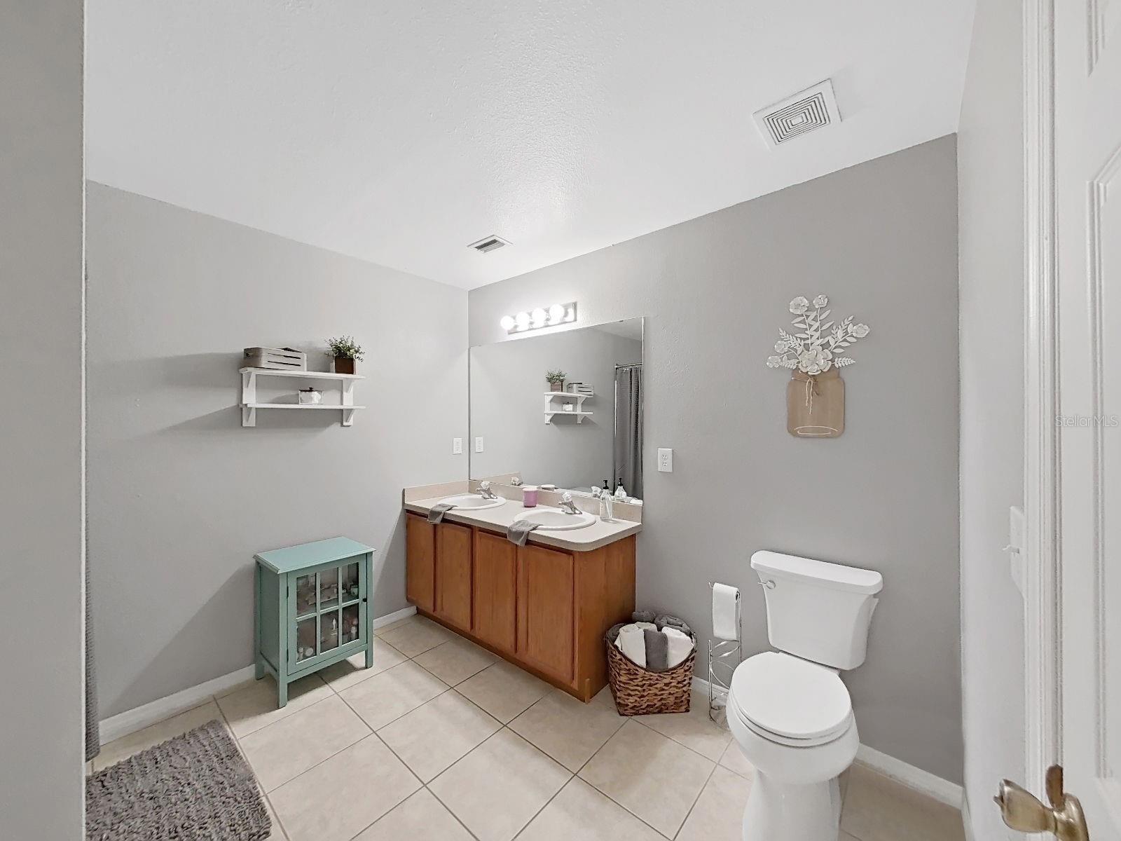 Primary Bathroom. Clean, calm, and ready for your morning routine. Two sinks and a soothing neutral palette.