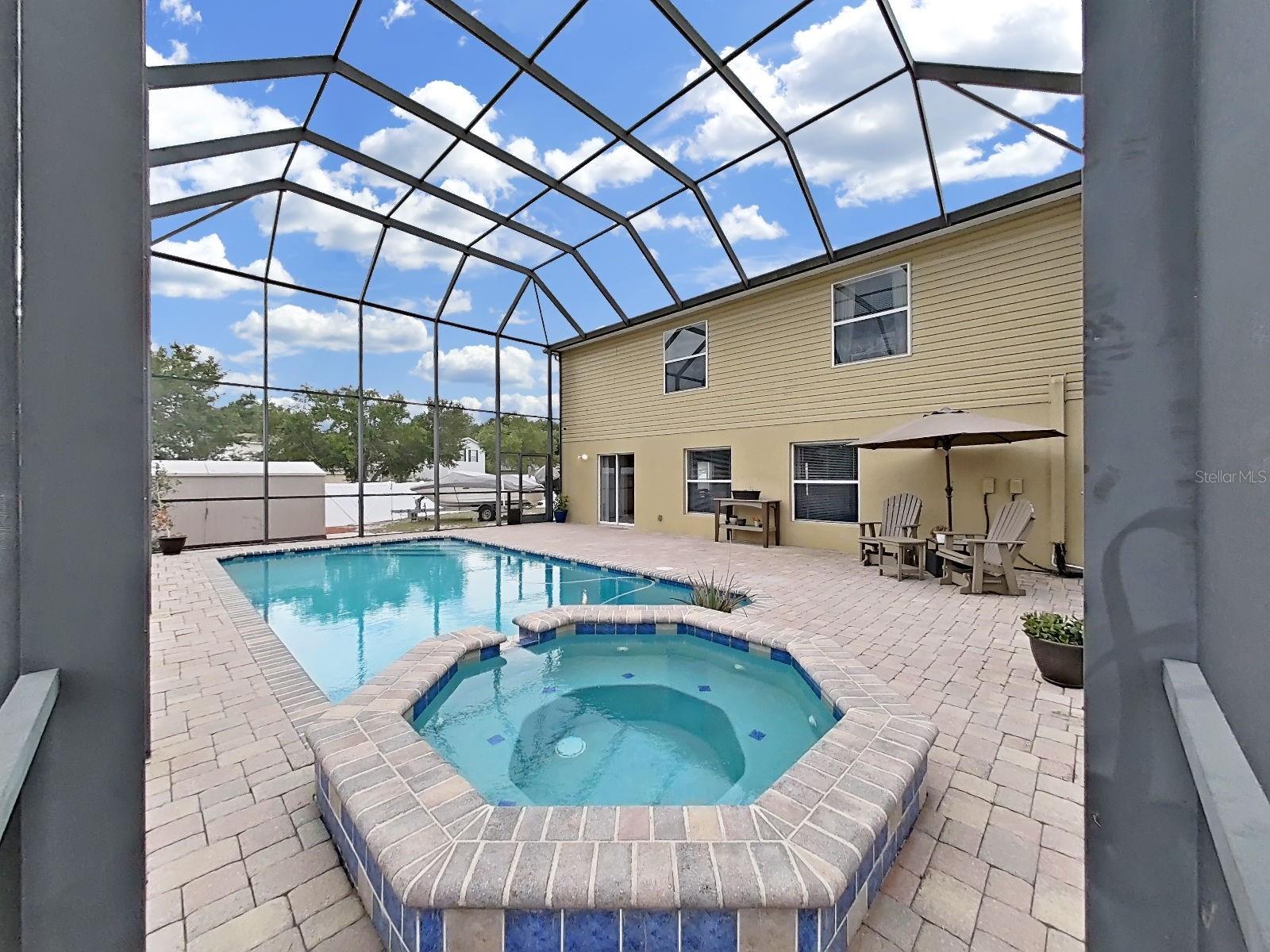 Screened pool & spillover spa with paver deck and plenty of room for seating - perfect for Florida living!