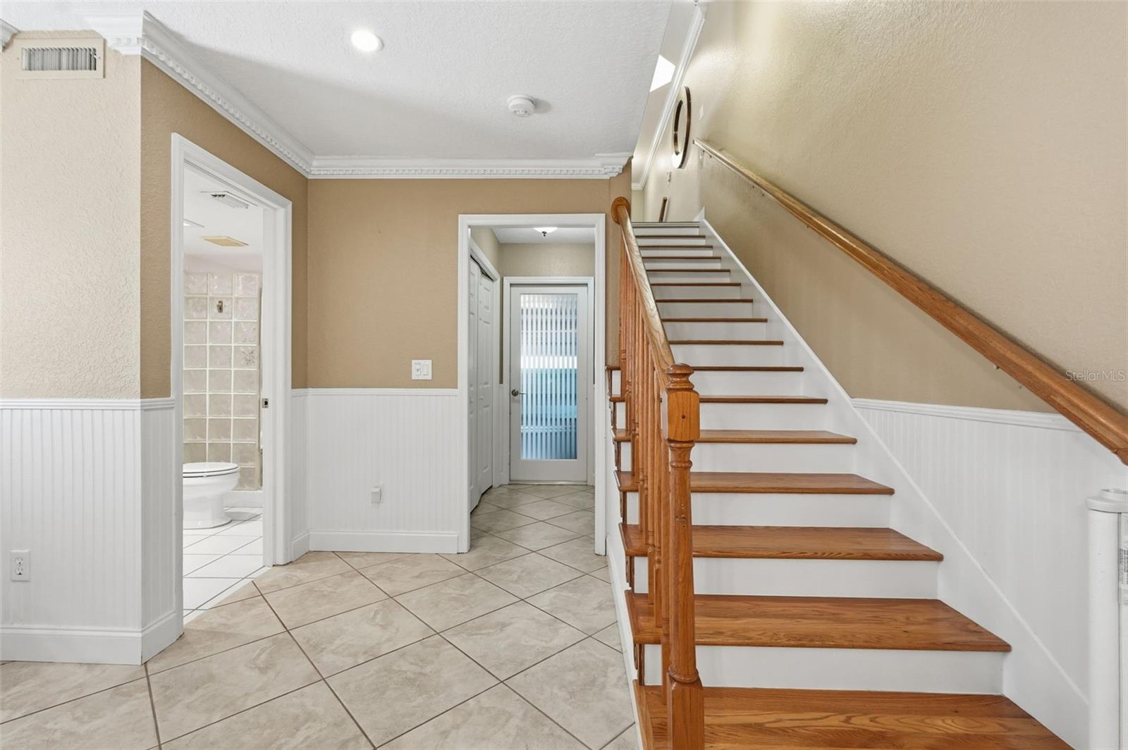 Stairs to 1st Floor: Includes large closet, bathroom with shower  and back entry into garage.