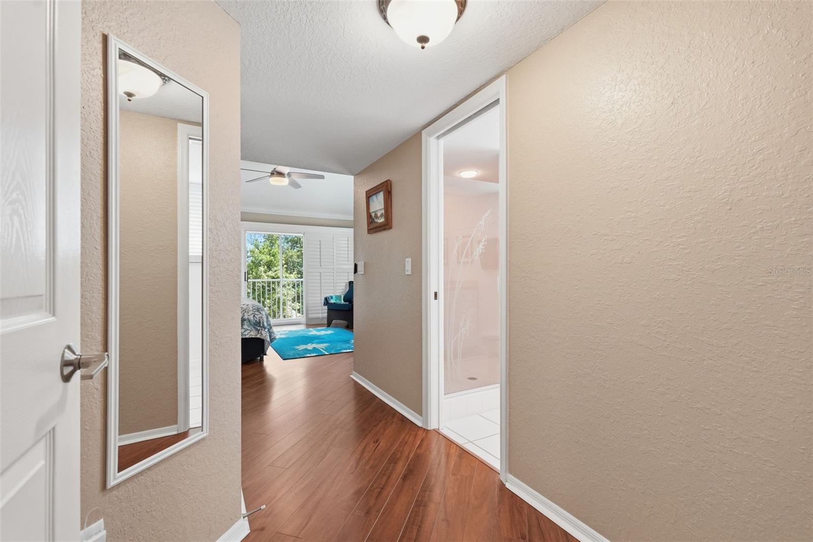 Entry to Rear South Facing Primary.  Closet to the left bath to the right