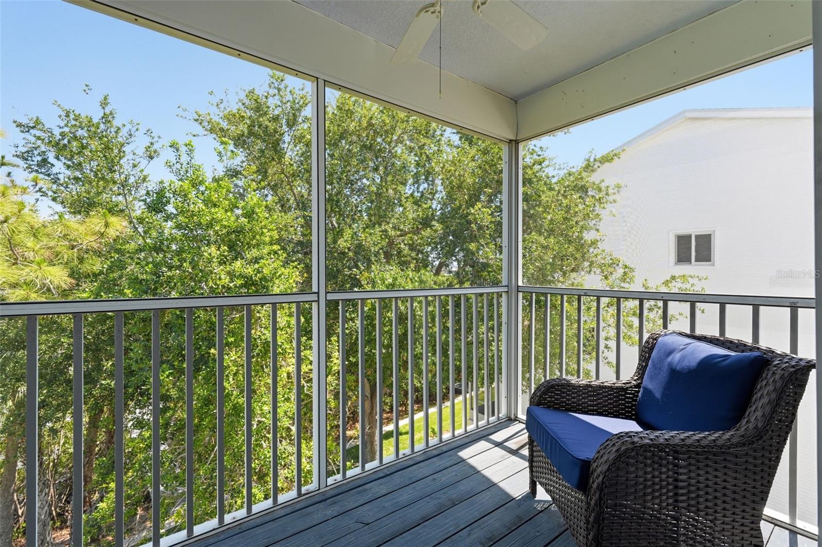 3rd Floor screened patio overlooking tranquil green space and water