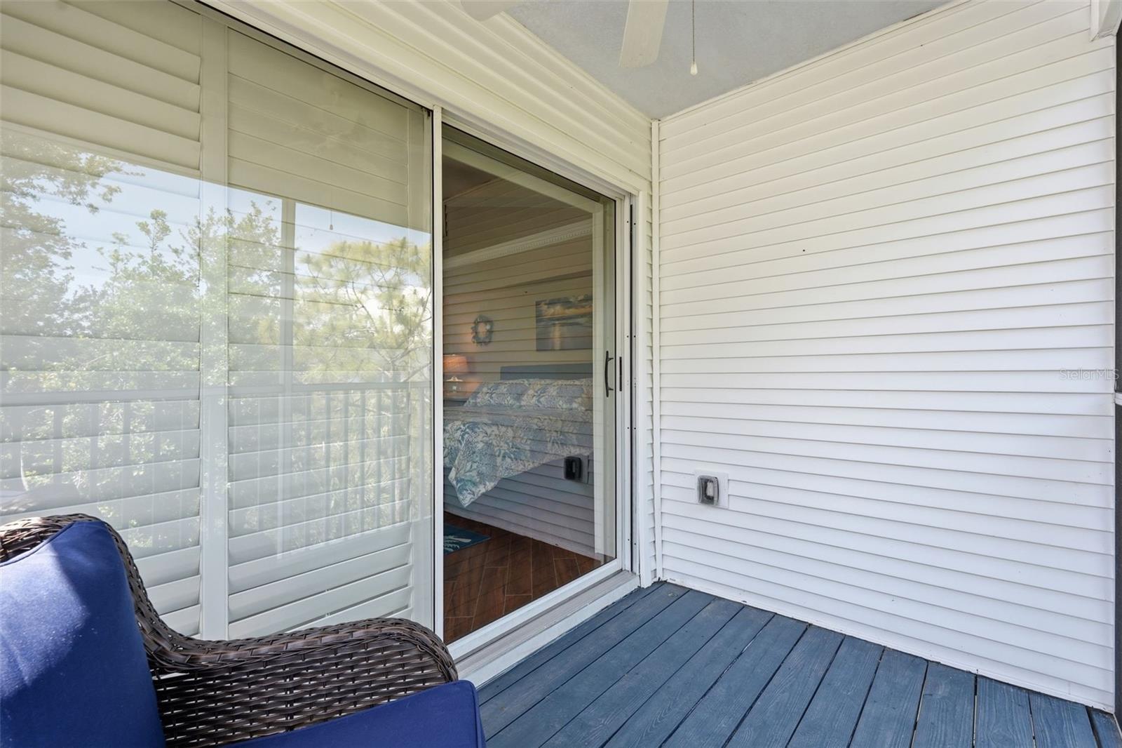 3rd Floor screened patio overlooking tranquil green space and water