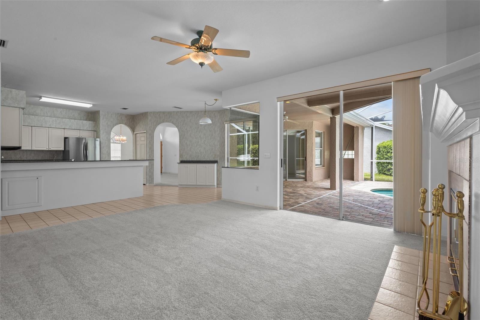 Living area with wood-burning fireplace and access to outdoor space.