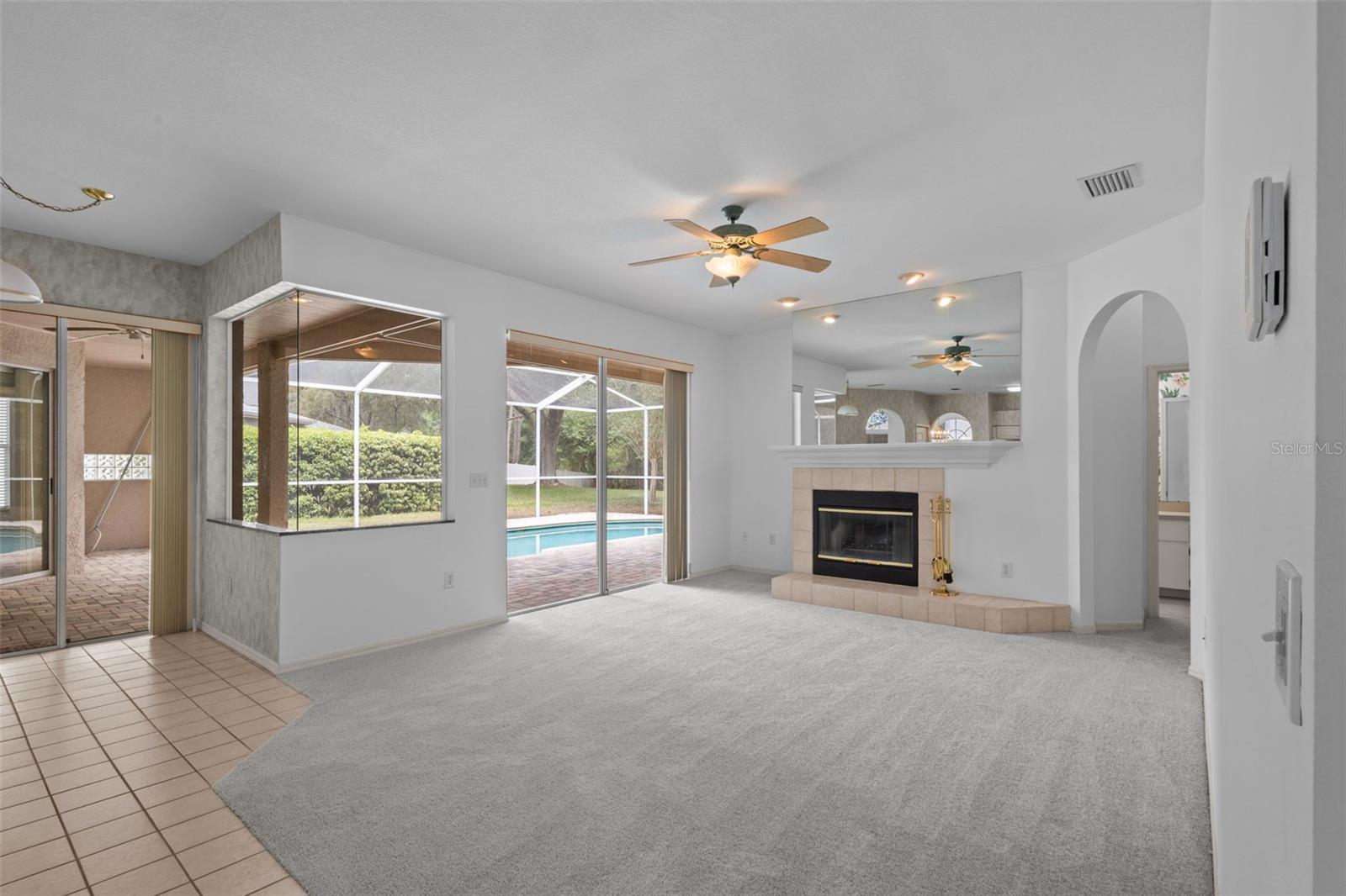 Living area with wood-burning fireplace and access to outdoor space.