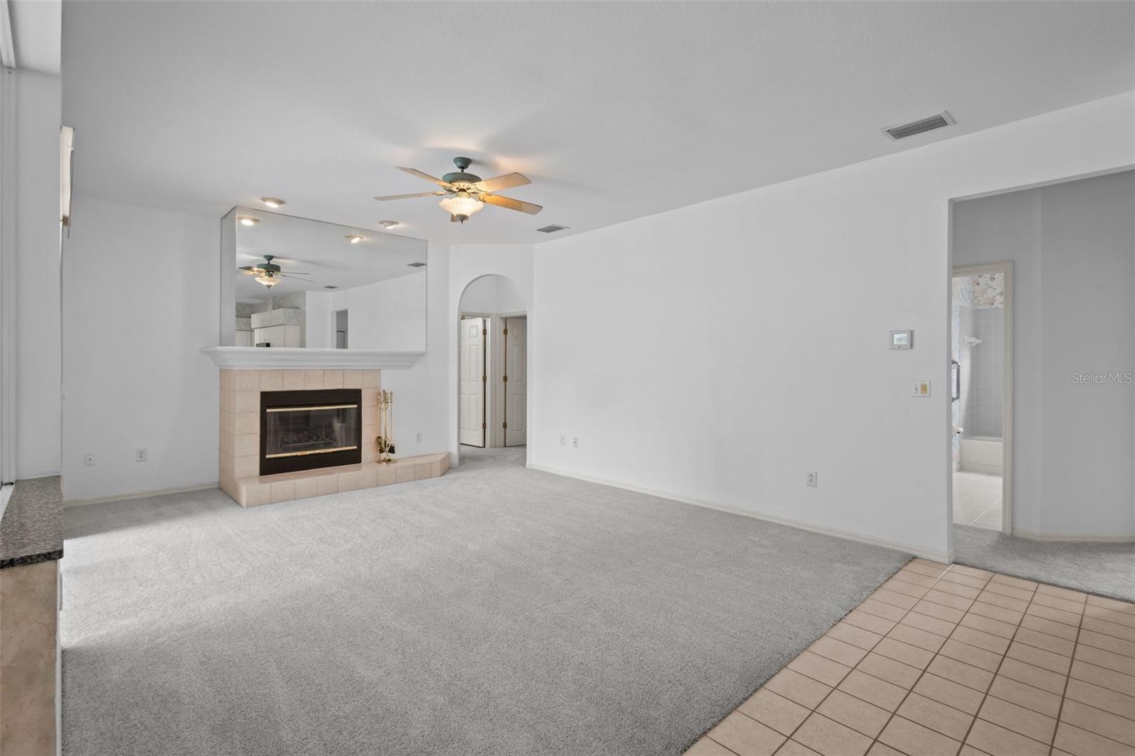 Living area with wood-burning fireplace and access to outdoor space.