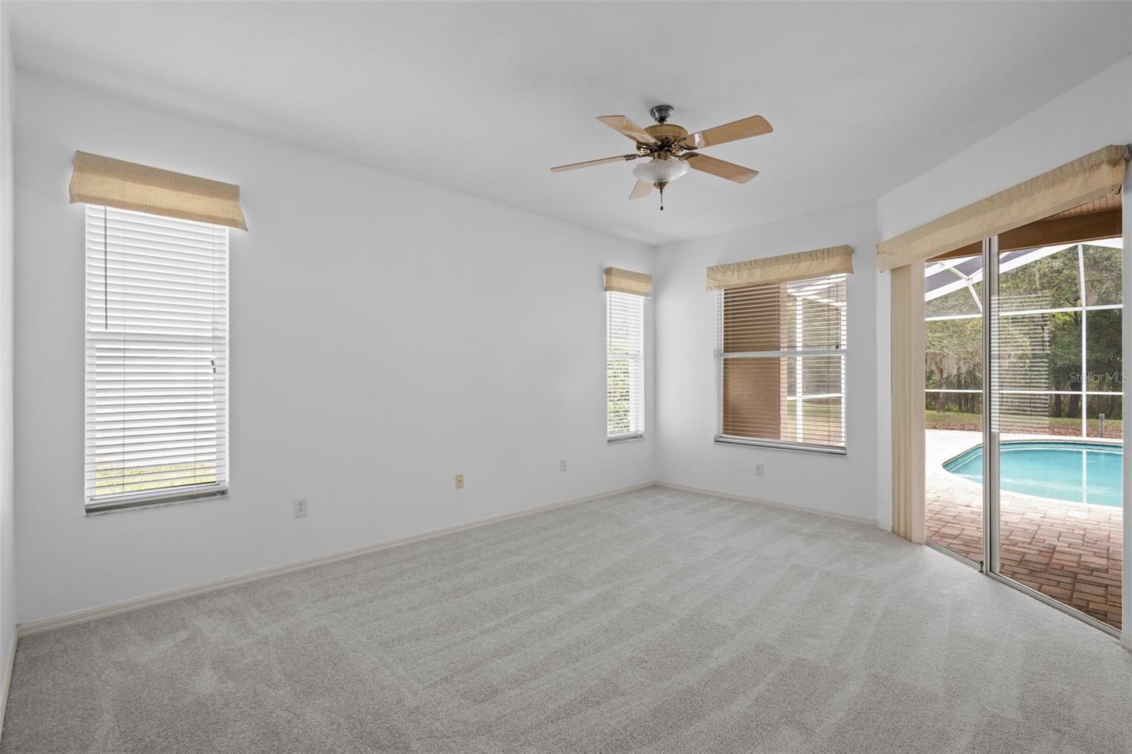 Primary suite located off the main living area with direct pool access.