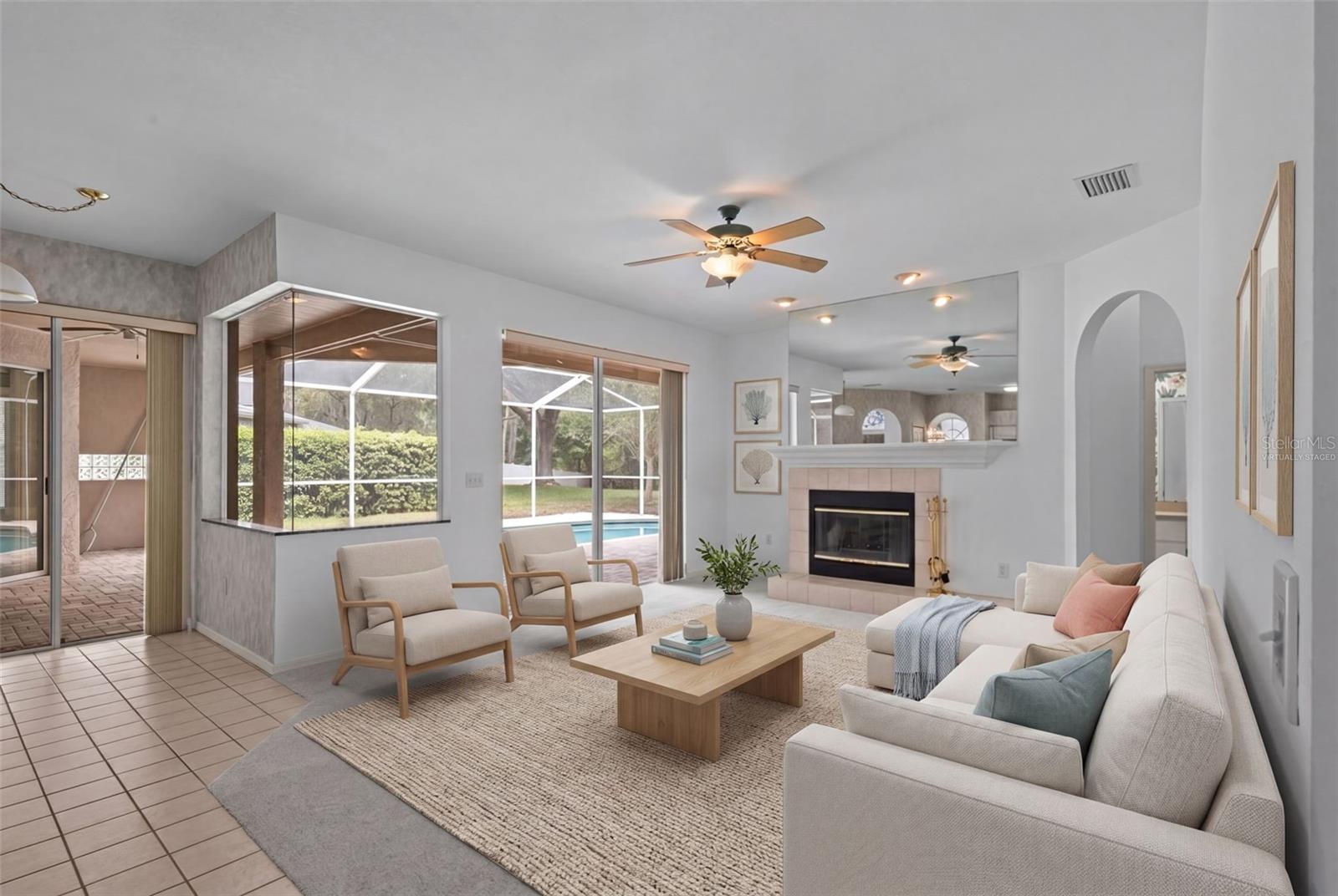 Living area with wood-burning fireplace and access to outdoor space. - virtually staged