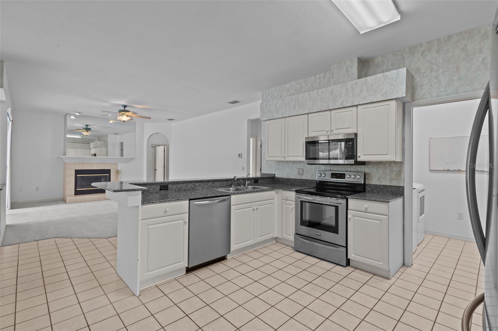 Kitchen with adjacent breakfast nook and open connection to living space.