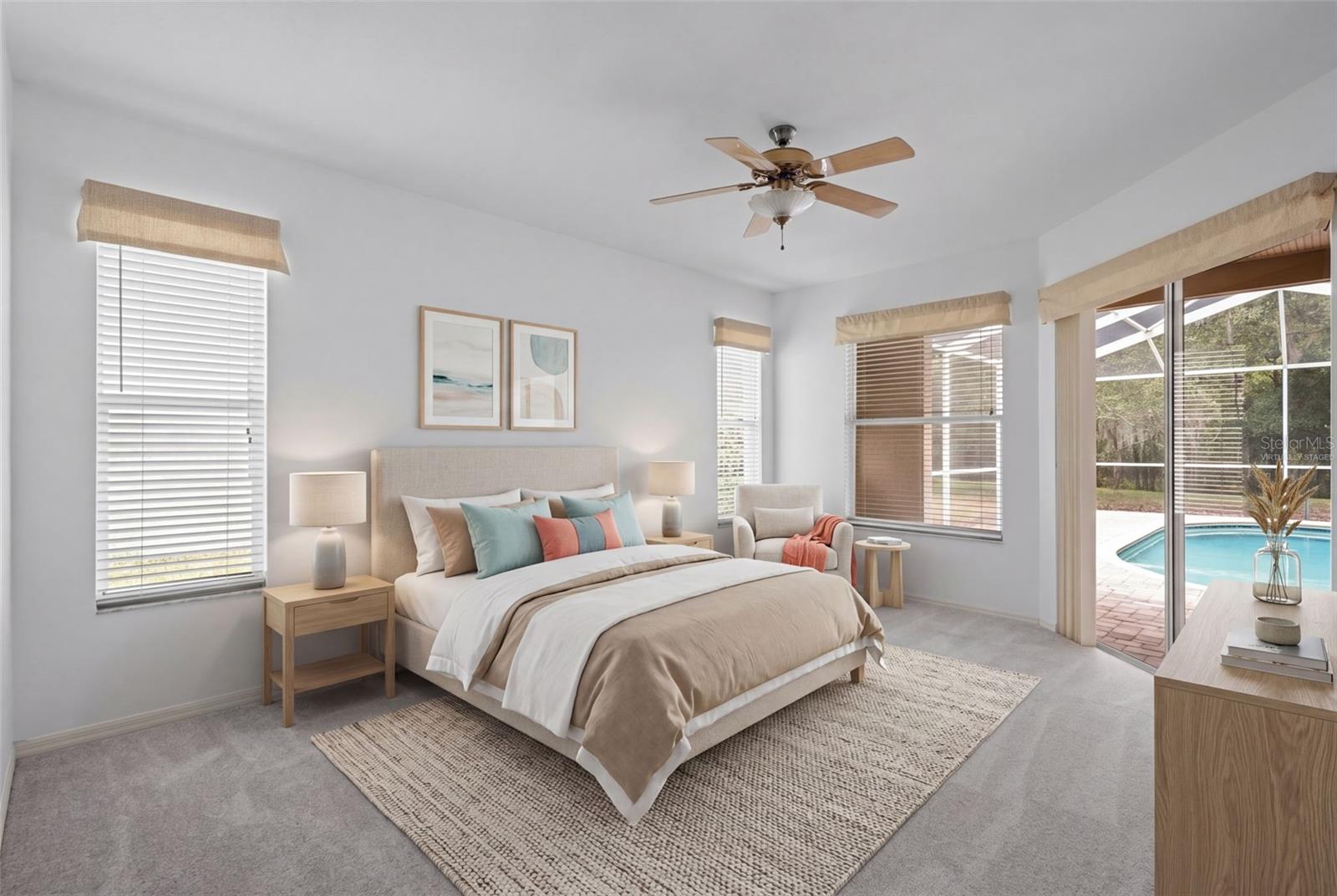Primary suite located off the main living area with direct pool access. - virtually staged