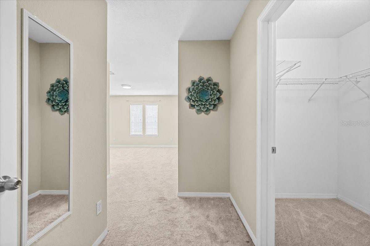 Entry Into Primary Bedroom Walk in closet on the right