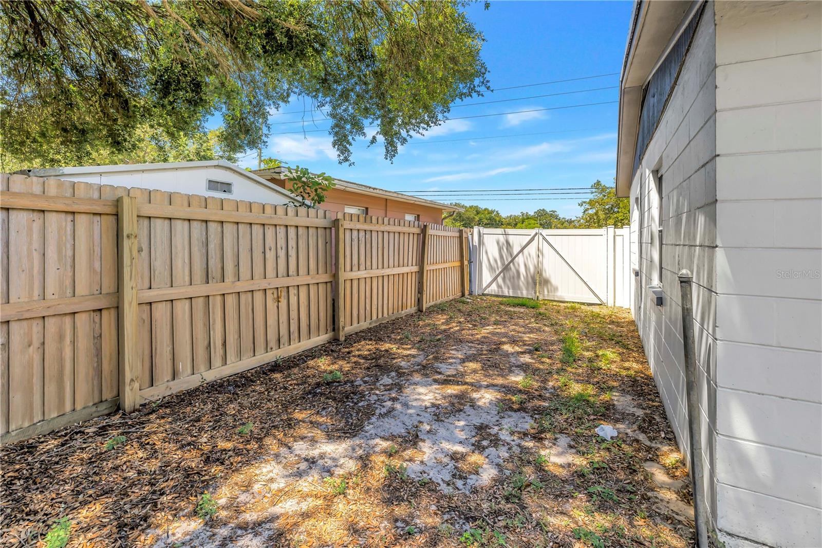 Side yard has space to park a boat or trailer with double gate