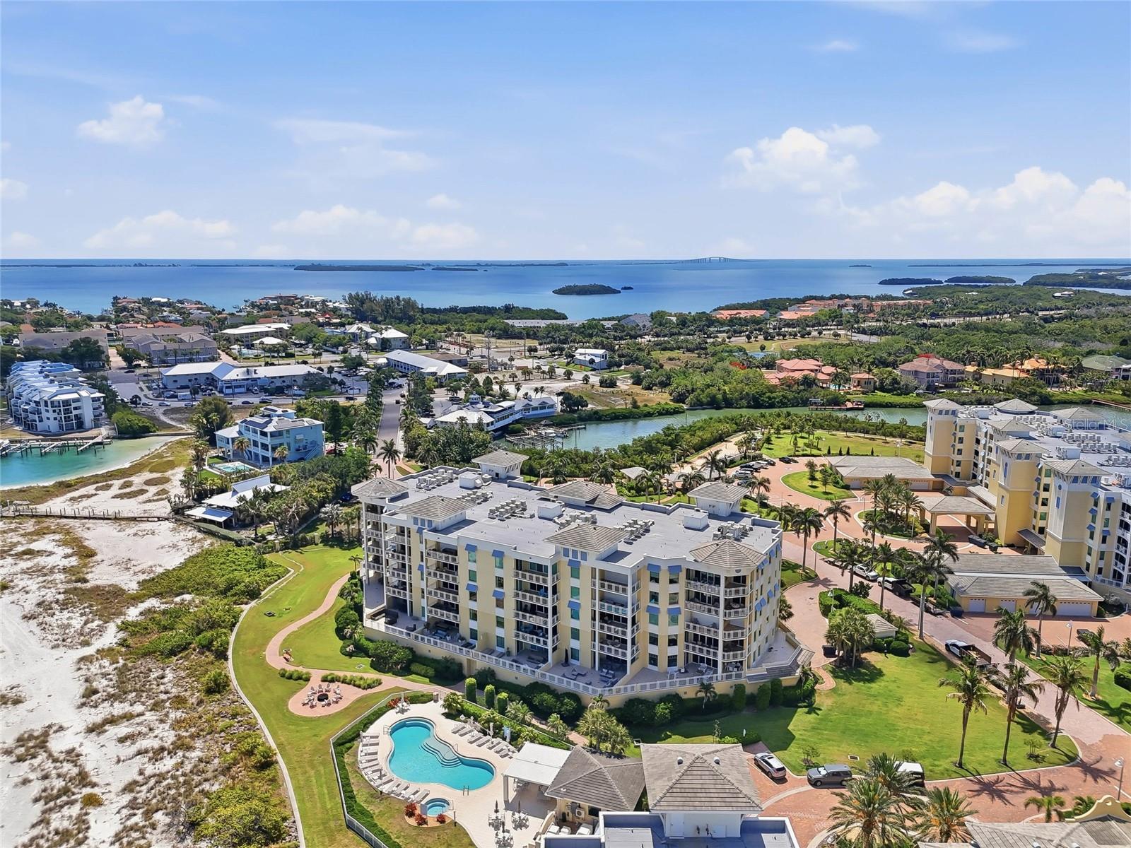 Aerial view highlighting the beachfront location and resort-style pool. Tierra Verde and the beaches close to Fort Desoto is an amazing Paradise!  Live here now!
