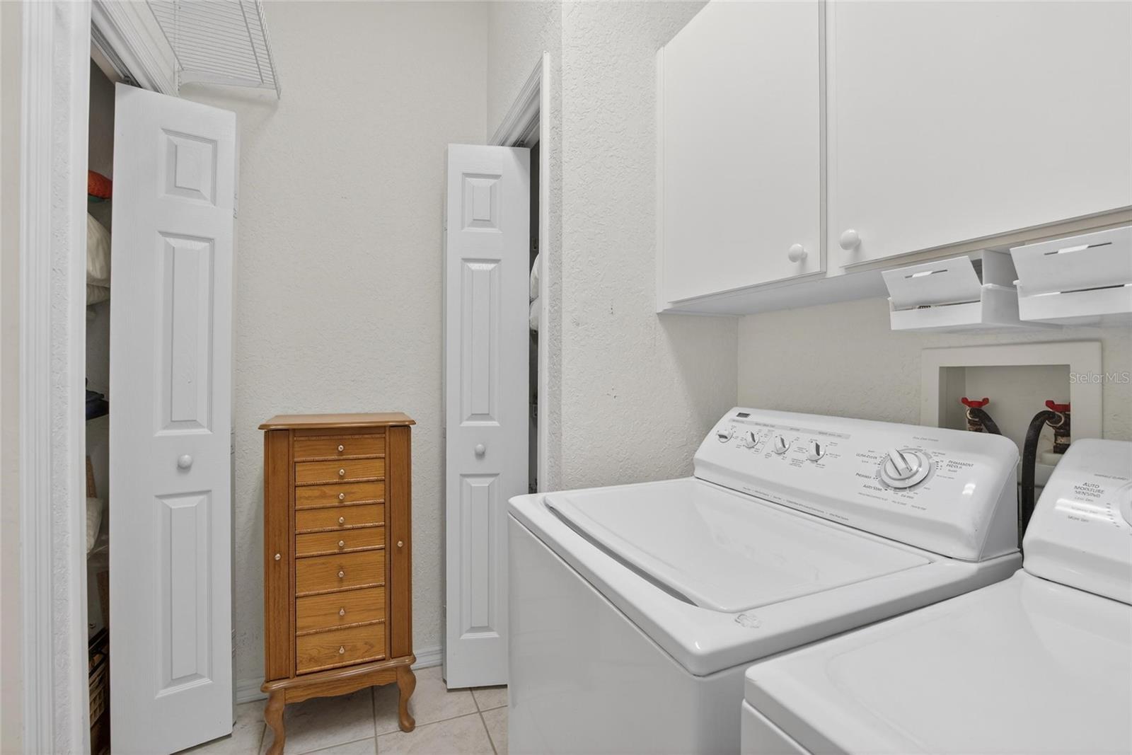 Laundry room with storage closets