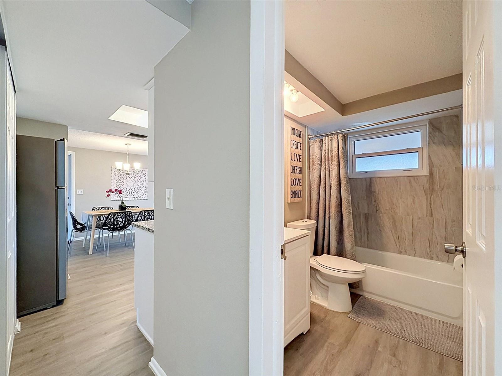 View of Main Bathroom with flow into the Kitchen and Dining Room