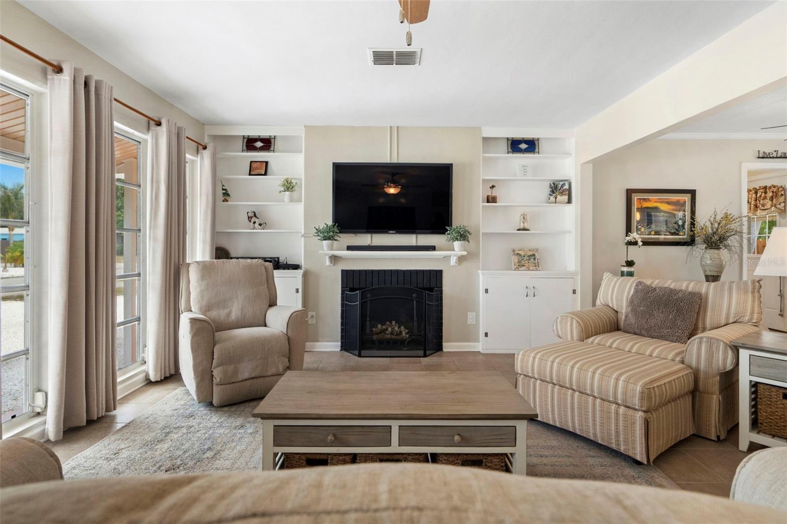 The living room features original built-ins and a fireplace.