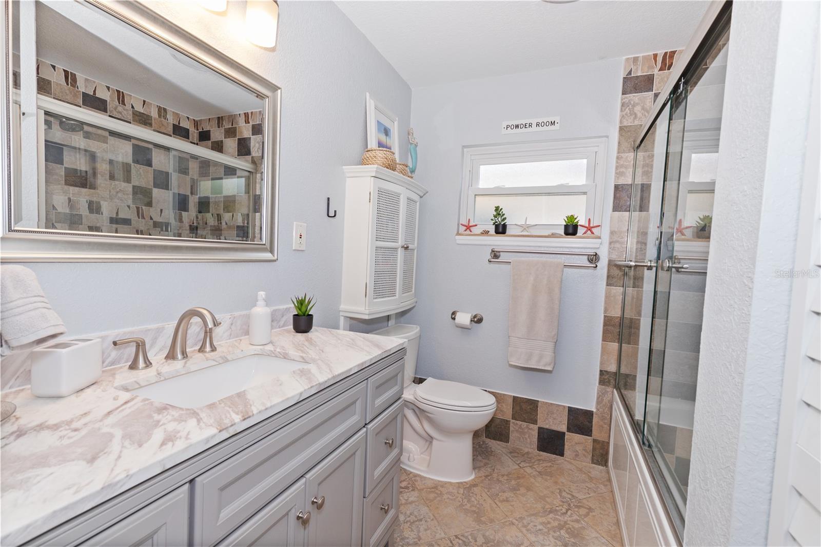 Main bathroom has a closet for linens and towels