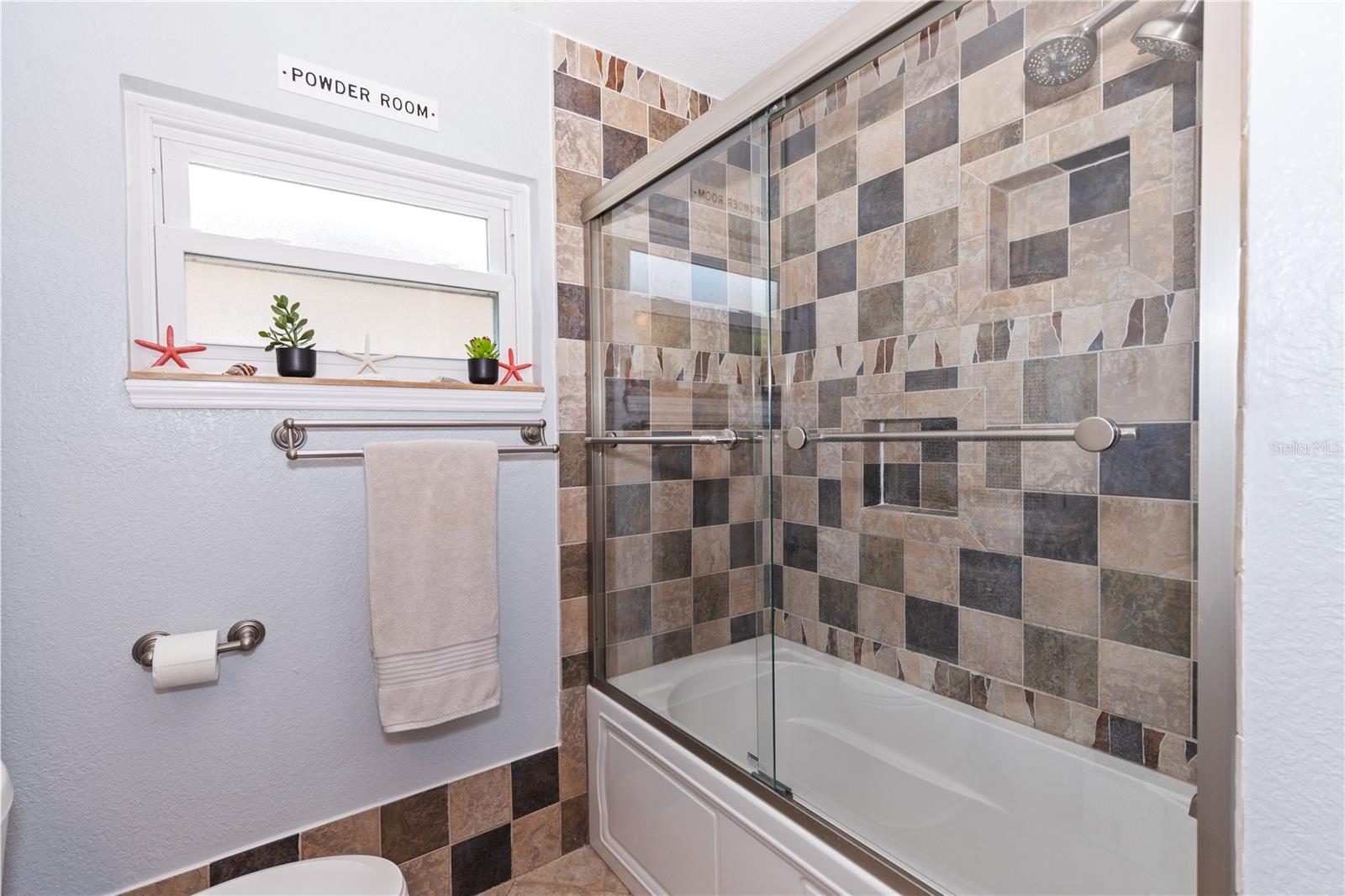 Tub/Shower with newer shower doors and fictures
