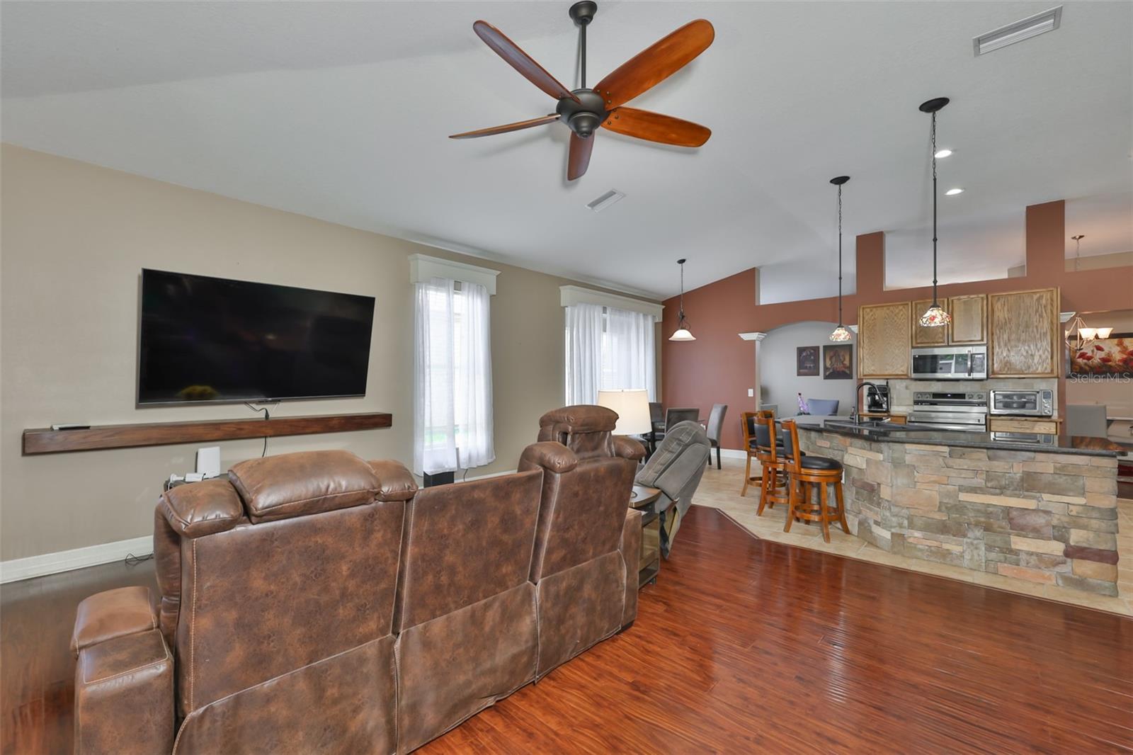 Engineered wood in the family room and a large ceiling fan above