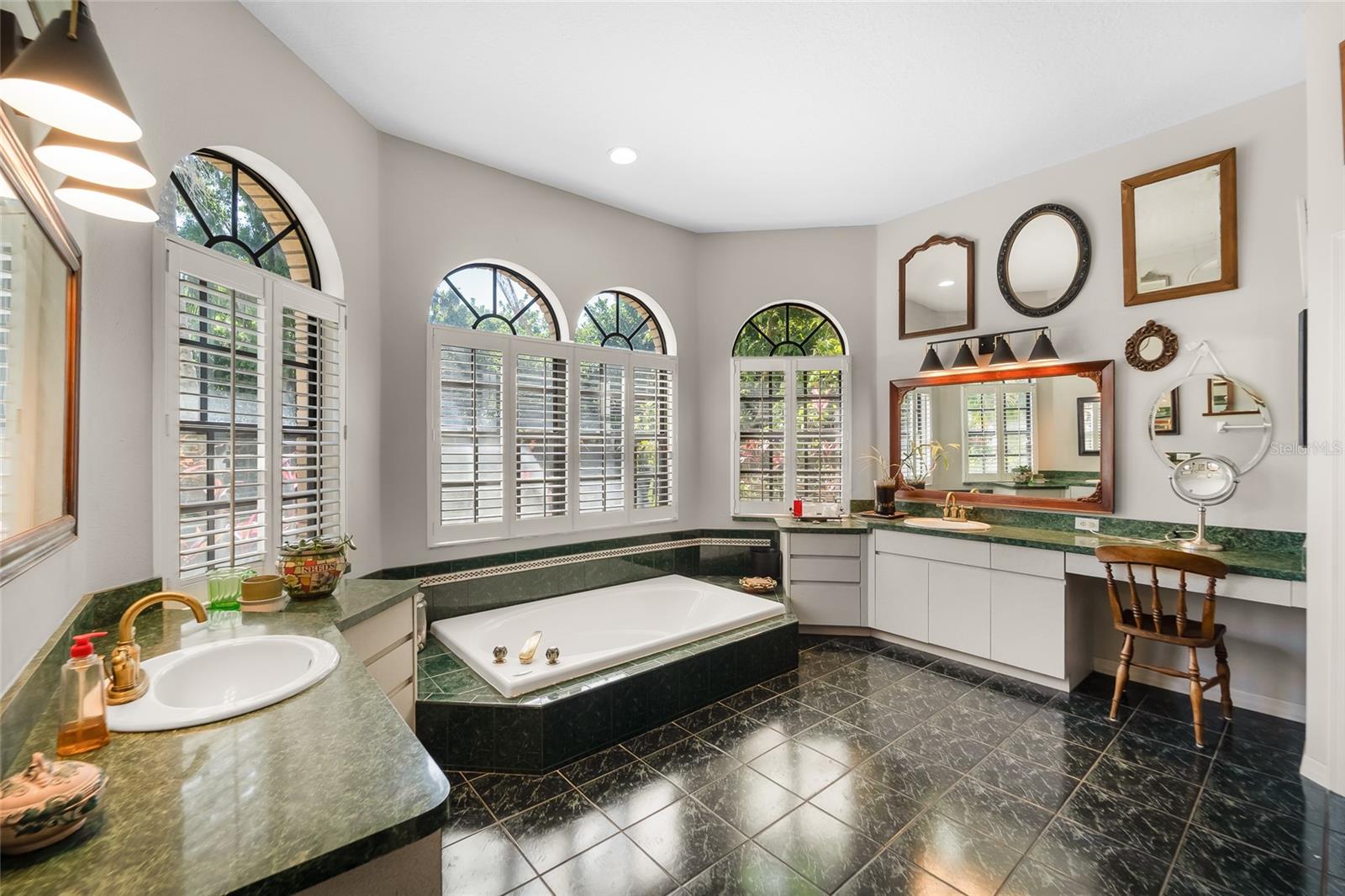 Huge primary bathroom with split vanities
