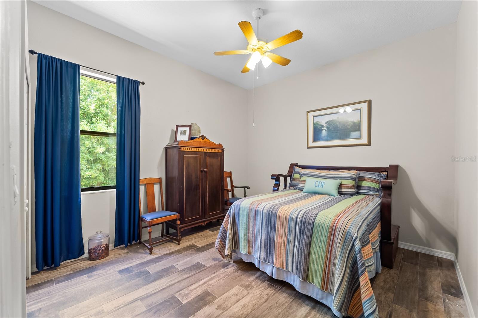 12x15 guest bedroom with view of lake and rose garden