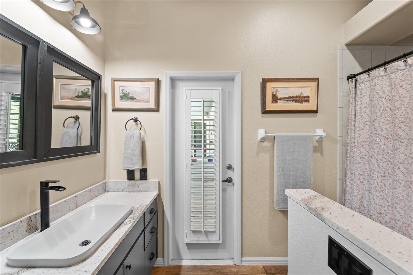 Guest bathroom has door to pool area