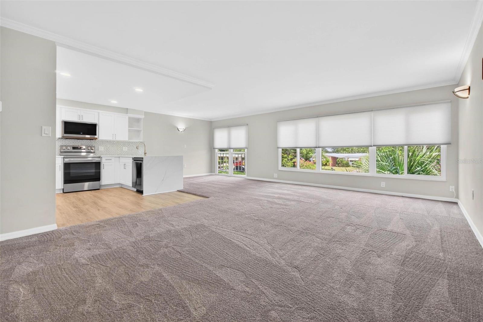 Open Floor Plan with Luxurious Carpeting and Large Impact Resistant Windows