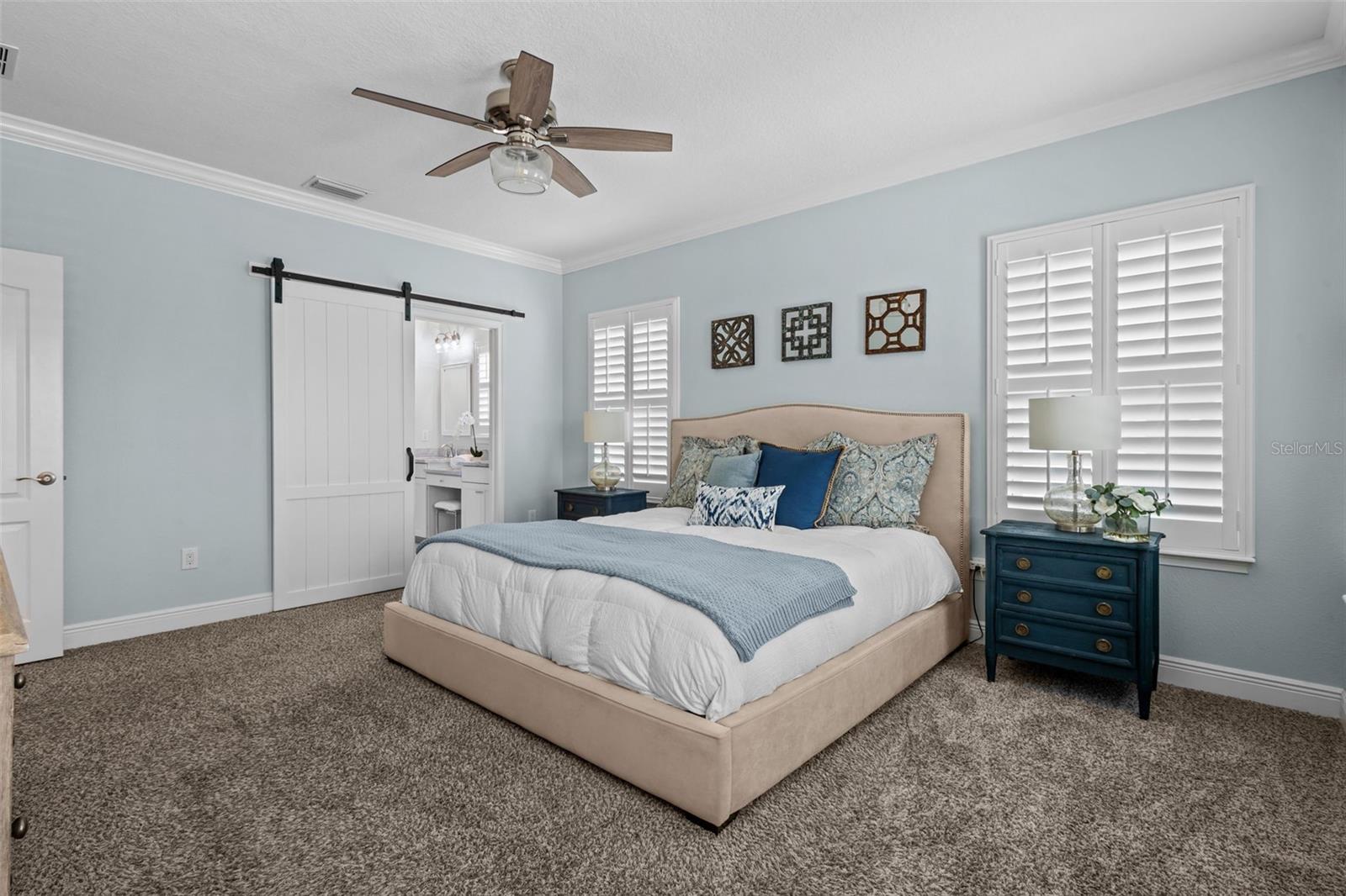Spacious upstairs retreat with crown molding, natural light, and a built-in window seat with storage.