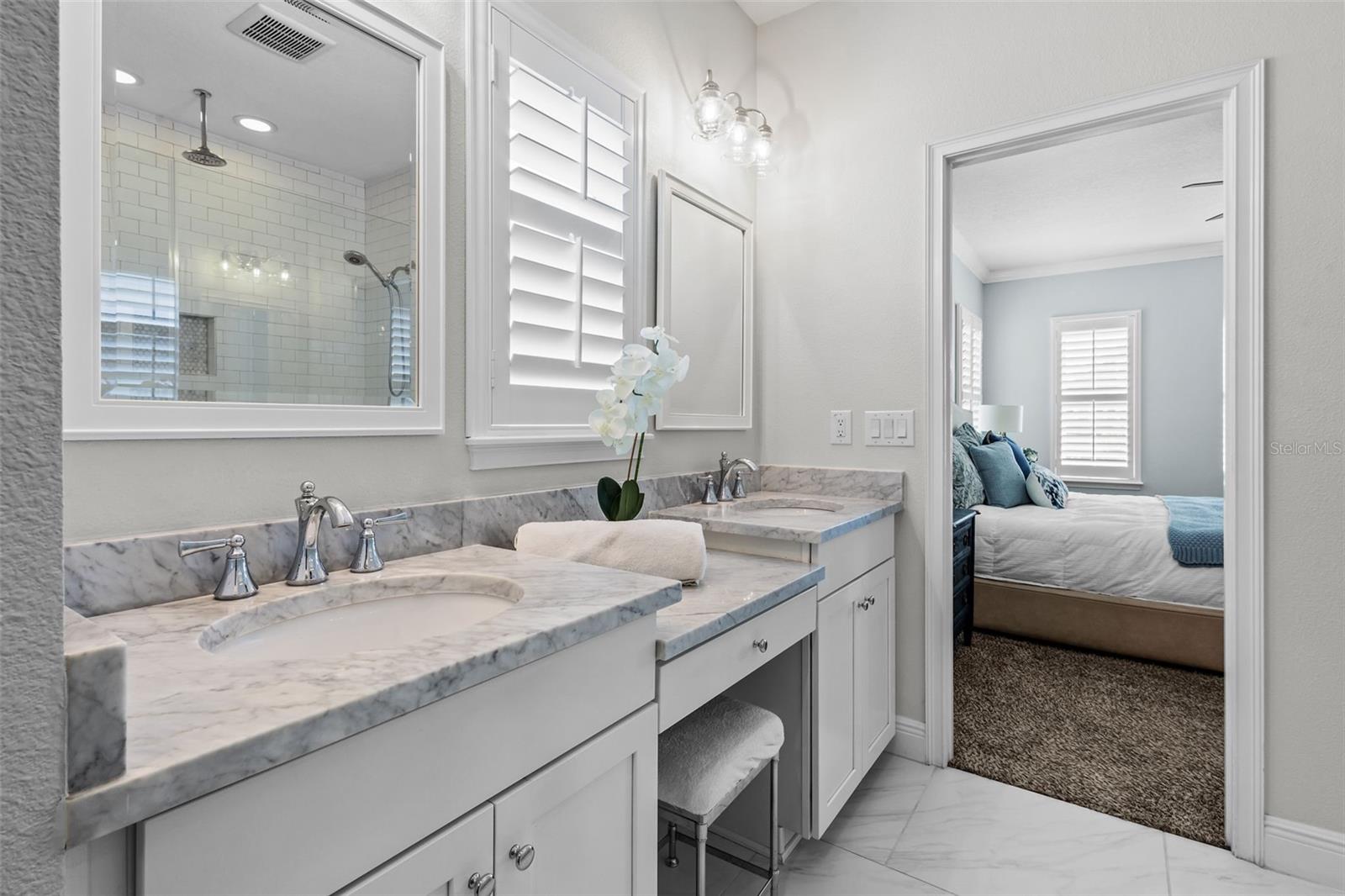 Marble countertops, dual sinks, and a walk-in shower with dual showerheads.