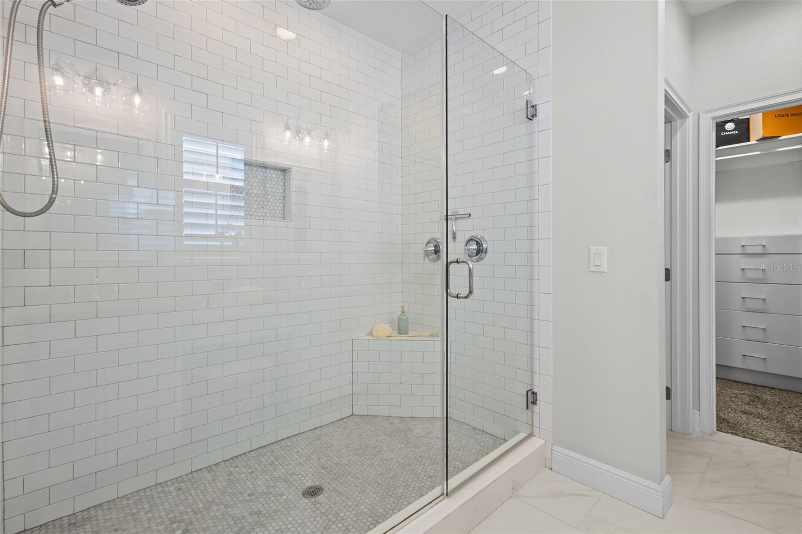Marble countertops, dual sinks, and a walk-in shower with dual showerheads.