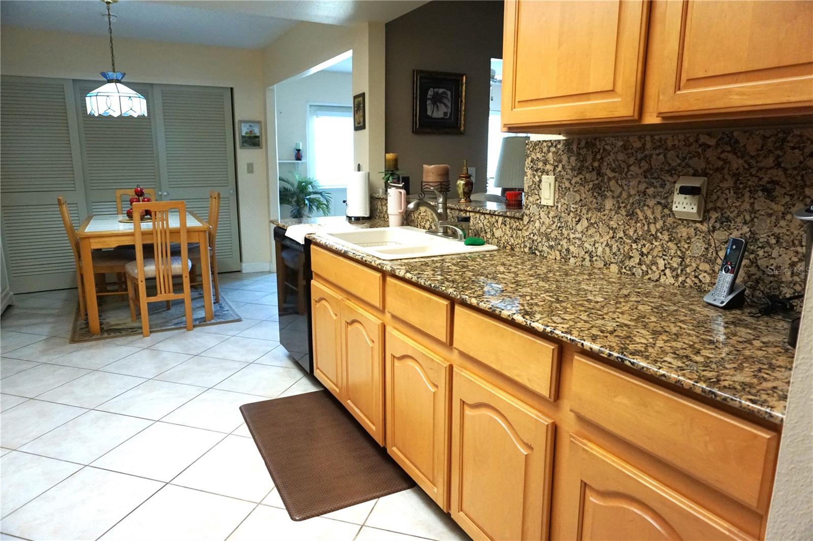 Kitchen looking toward eat in area and laundry closet