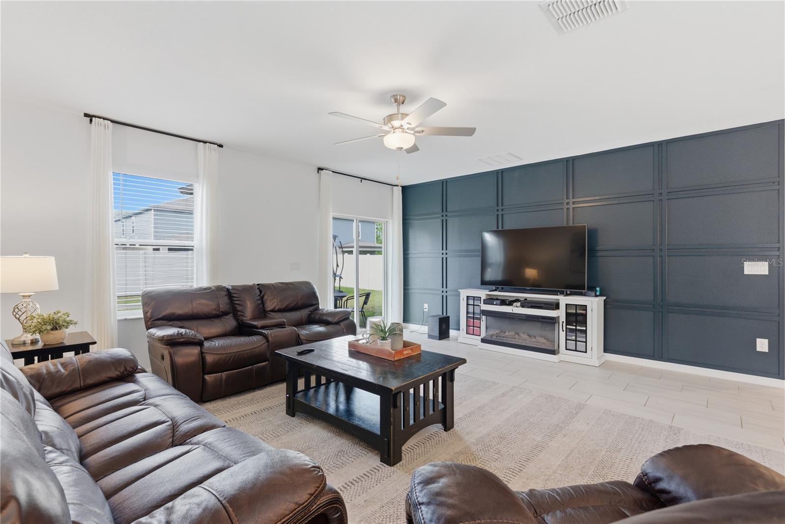 Grand room with decorative accent wall