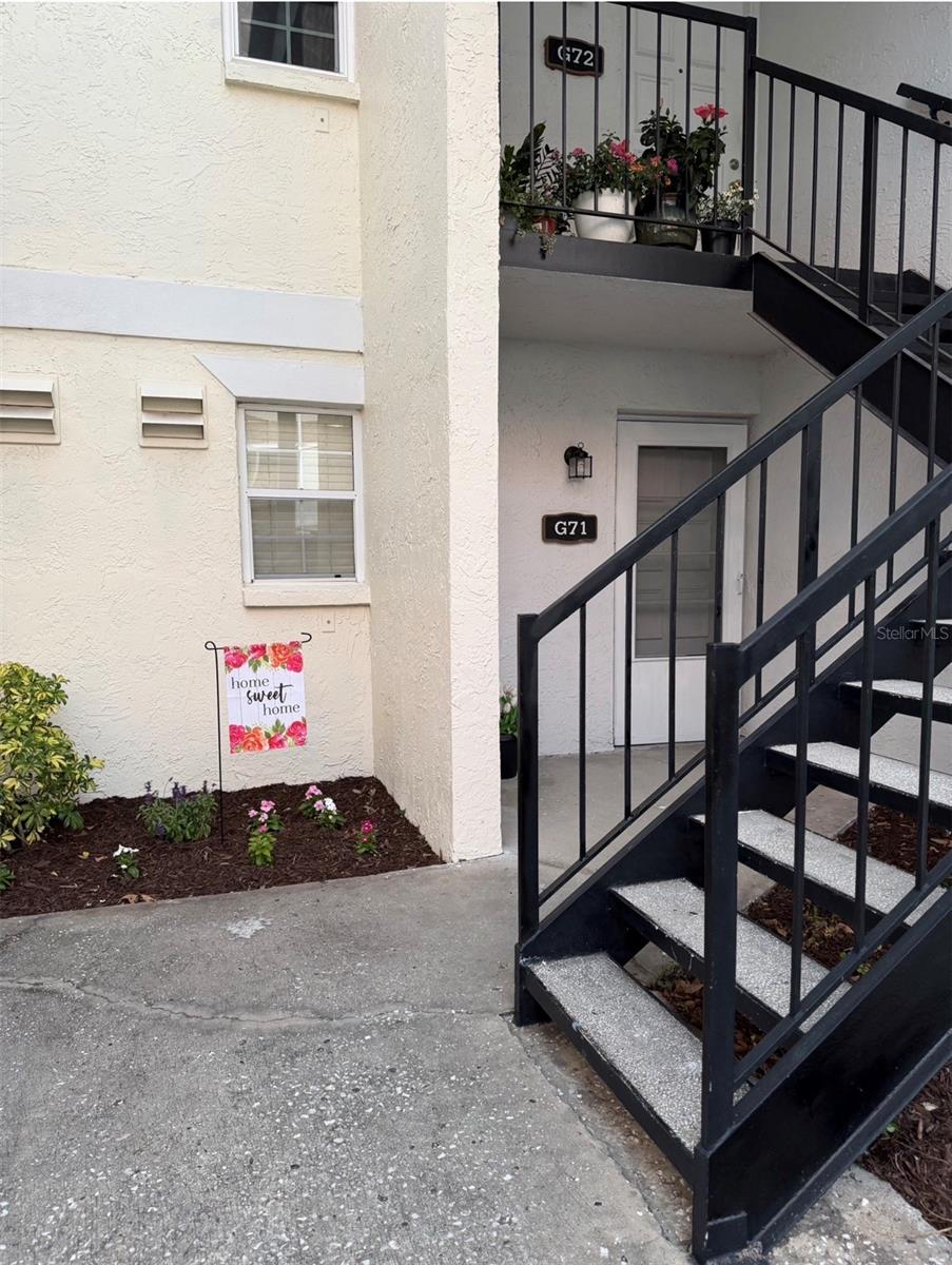 WELCOME TO G71.... Fresh flowers and mulch, and there's a storm door for extra protection and natural light or breeze when desired.