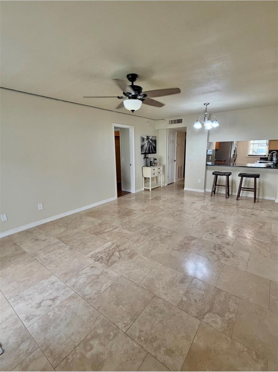 The living is 20x12 and features travertine floors.