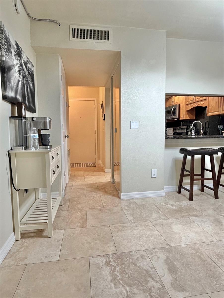 Travertine floors are throughout the living room and the kitchen and hallways. The coffee bar can stay with a great offer.