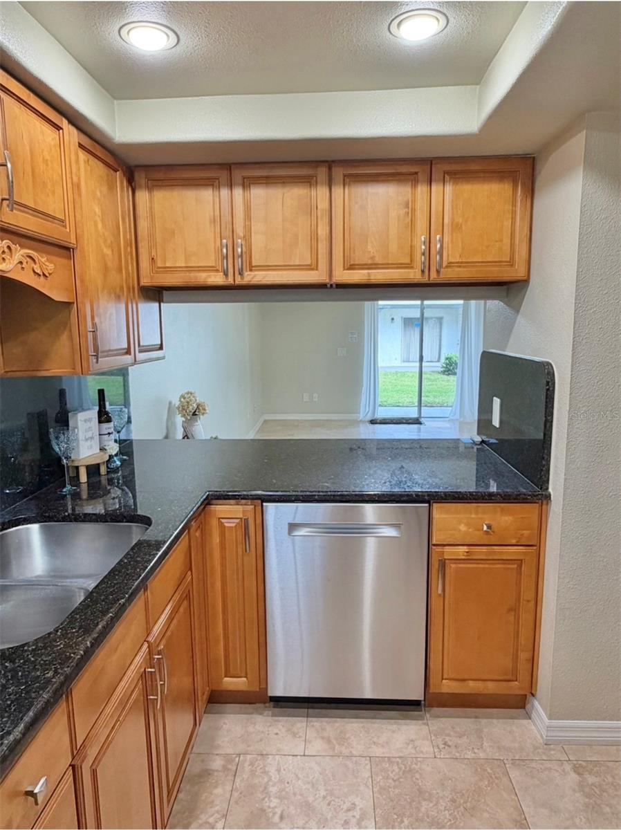 The Kitchen has an opening and bar space to the living room where 2-3 stools can go.